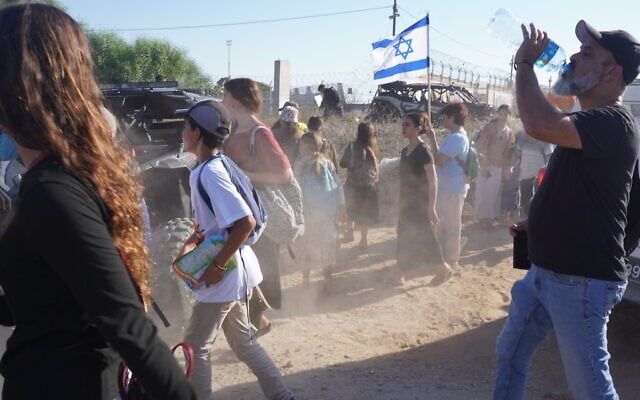 Settlement activists breach an IDF roadblock during a march to the Gaza border in support of renewing Jewish settlement in the territory, on July 19, 2026. (Charlie Summers/Times of Israel)