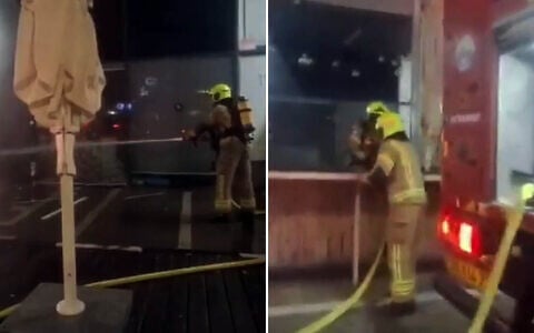 Firefighters put out a blaze sparked by a grenade attack on a branch of Japanika in Afula, July 14, 2026 (Screen grab/Israel Fire and Rescue Services)
