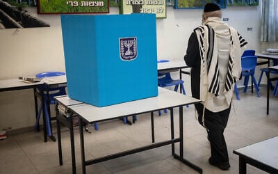 Illustrative: An ultra-Orthodox man casts his ballot at a voting station on the morning of municipal elections, in Bnei Brak, on February 27, 2024. (Chaim Goldberg/Flash90/File) Illustrative: An ultra-Orthodox man casts his ballot at a voting station on the morning of municipal elections, in Bnei Brak, on February 27, 2024. (Chaim Goldberg/Flash90/File)