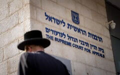 Illustrative: A man outside the Chief Rabbinate headquarters in Jerusalem, October 31, 2024 (Chaim Goldberg/Flash90)