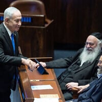 Prime Minister Benjamin Netanyahu (left) speaks to United Torah Judaism lawmakers Moshe Gafni (right) and Yitzhak Goldknopf in the Knesset plenum in Jerusalem, July 1, 2026. (Yonatan Sindel/Flash90)