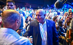 Gadi Eisenkot (right) greets supporters at the launch of his Yashar party’s election campaign, in Hod Hasharon, central Israel, June 30, 2026. (Avshalom Sassoni/Flash90)