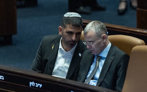 Justice Minister Yariv Levin speaks with Communications Minister Shlomo Karhi during a Knesset plenum session, on July 8, 2026. (Yonatan Sindel/Flash90)