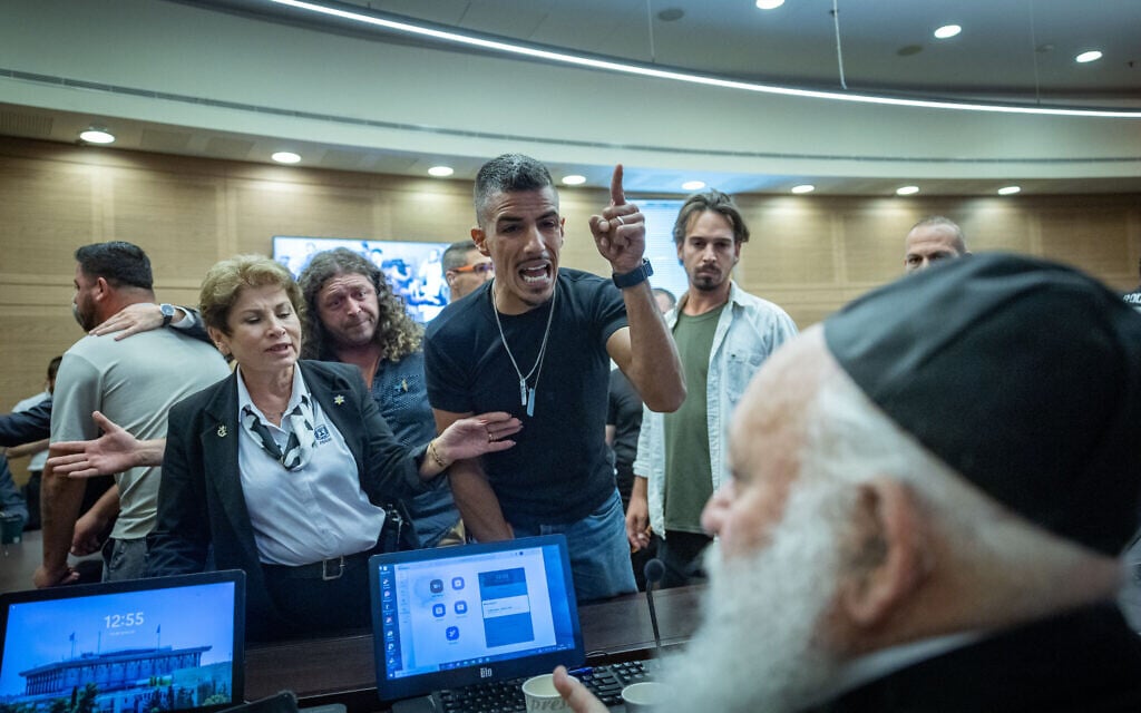 Combat veterans suffering from PTSD react toward MK Yitzhak Goldknopf during a Knesset House Committee meeting in Jerusalem on July 9, 2026. (Yonatan Sindel/Flash90)