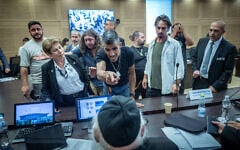 Combat veterans suffering from PTSD react during a House Committee hearing on the so-called Torah Study bill, at the Knesset on July 9, 2026.  Yitzhak Goldknopf is seated with back to camera. (Yonatan Sindel/Flash90)