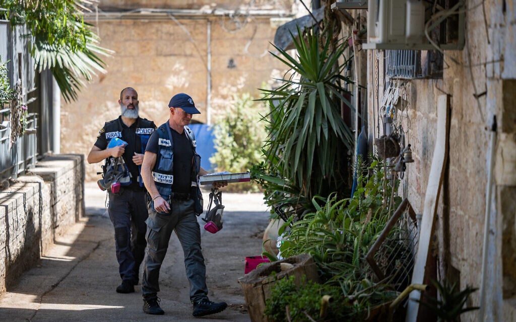 Police officers stand at the scene of the murder of a 19-year-old man in the Nachlaot neighborhood of Jerusalem, July 12, 2026 (Chaim Goldberg/Flash90) Police officers stand at the scene of the murder of a 19-year-old man in the Nachlaot neighborhood of Jerusalem, July 12, 2026 (Chaim Goldberg/Flash90)