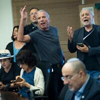 Opposition Yesh Atid MKs Elazar Stern (left) and Meir Cohen (right) shout during a Knesset Foreign Affairs and Defense Committee hearing on legislation to freeze the arrests of ultra-Orthodox draft dodgers, July 12, 2026. (Chaim Goldberg/Flash90)