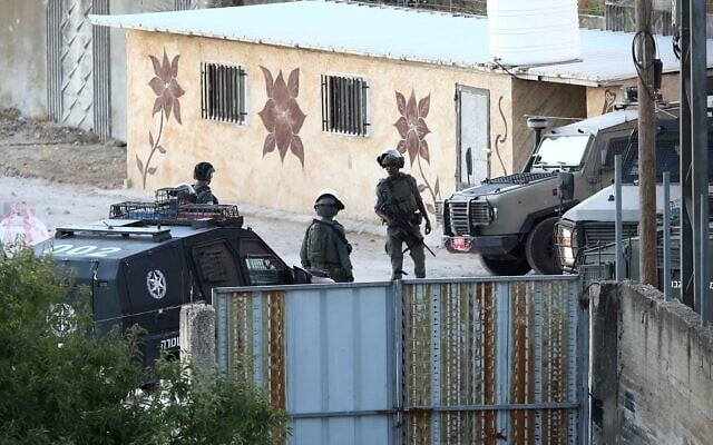 Israeli security forces operate during a military raid in the West Bank city of Hebron, July 14, 2026 (Wisam Hashlamoun/Flash90)