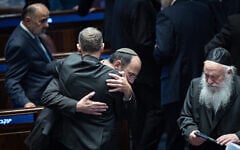Religious Zionism MK Simcha Rothman celebrates with Justice Minister Yariv Levin (back to camera) following the passage of a law to weaken the powers of the attorney general, at the Knesset plenum in Jerusalem on July 15, 2026. (Yonatan Sindel/Flash90)