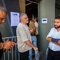People stand at polling station during the Likud party's primaries, which were halted following a court order, at Menora Mivtachim Arena in Tel Aviv, July 16, 2026 (Avshalom Sassoni/Flash90)