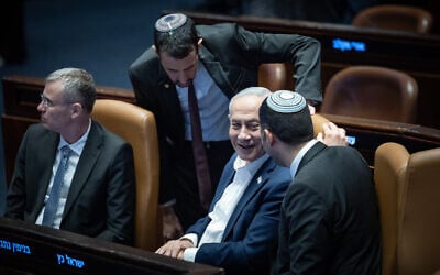 Prime Minister Benjamin Netanyahu (center) together with fellow Likud ministers Yariv Levin (left) and Shlomo Karhi (right) attend a Knesset plenum session at which a law boosting government authority over media was passed, July 16, 2026. (Yonatan Sindel/Flash90) Prime Minister Benjamin Netanyahu (center) together with fellow Likud ministers Yariv Levin (left) and Shlomo Karhi (right) attend a Knesset plenum session at which a law boosting government authority over media was passed, July 16, 2026. (Yonatan Sindel/Flash90)