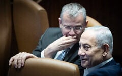 Prime Minister Benjamin Netanyahu (right) and Justice Minister Yariv Levin talk in the Knesset on July 16, 2026, hours before parliament dispersed the following day ahead of general elections on October 27, 2026. (Yonatan Sindel/Flash90)