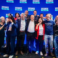 MKs Naama Lazimi (red jacket) and Gilad Kariv (to her right) celebrate with other Democrats party politicians after winning the No. 2 and No. 3 slots respectively on the party's Knesset slate, following party leader Yair Golan (to Kariv's right). The candidates gathered in Tel Aviv on July 20, 2026, after the party's primaries. (Avshalom Sassoni/Flash90)