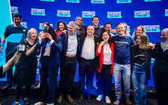 MKs Naama Lazimi (red jacket) and Gilad Kariv (to her right) celebrate with other Democrats party politicians after winning the No. 2 and No. 3 slots respectively on the party's Knesset slate, following party leader Yair Golan (to Kariv's right). The candidates gathered in Tel Aviv on July 20, 2026, after the party's primaries. (Avshalom Sassoni/Flash90)