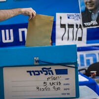 A person votes at a polling station during the Likud party internal vote in Jerusalem, July 27, 2026. (Chaim Goldberg/Flash90)