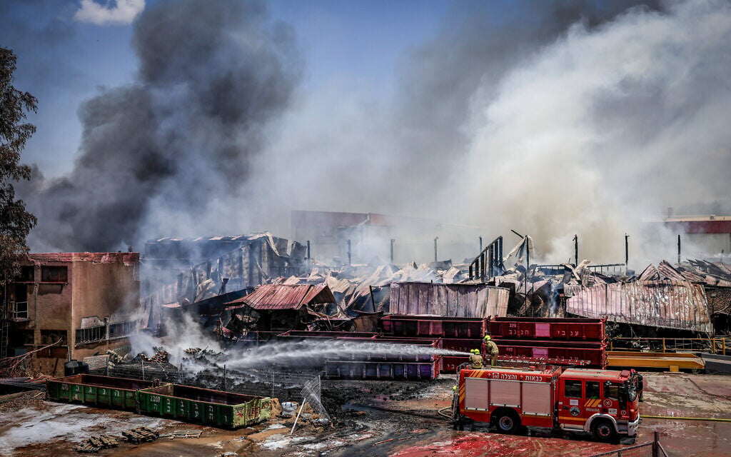 Firefighters try to extinguish a fire that broke out at a Strauss factory in Sderot, July 27, 2026. (Tsafrir Abayov/FLASH90)