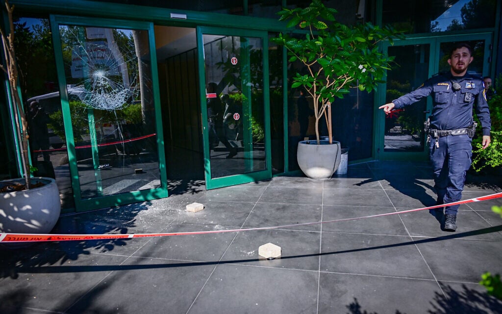 The damaged entrance door to the Channel 12 offices in Tel Aviv after it was shattered by an unknown suspect overnight, July 28, 2026. (Avshalom Sassoni/Flash90)