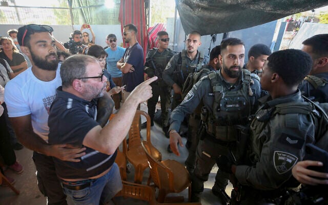 Hadash MK Ofer Cassif scuffles with Border Police officers during an event marking the first anniversary of the death of Palestinian activist Awdah Hathaleen, in the West Bank village of Umm al-Khair, in the Masafer Yatta area, July 28, 2026. (Wisam Hashlamoun/Flash90) Hadash MK Ofer Cassif scuffles with Border Police officers during an event marking the first anniversary of the death of Palestinian activist Awdah Hathaleen, in the West Bank village of Umm al-Khair, in the Masafer Yatta area, July 28, 2026. (Wisam Hashlamoun/Flash90)