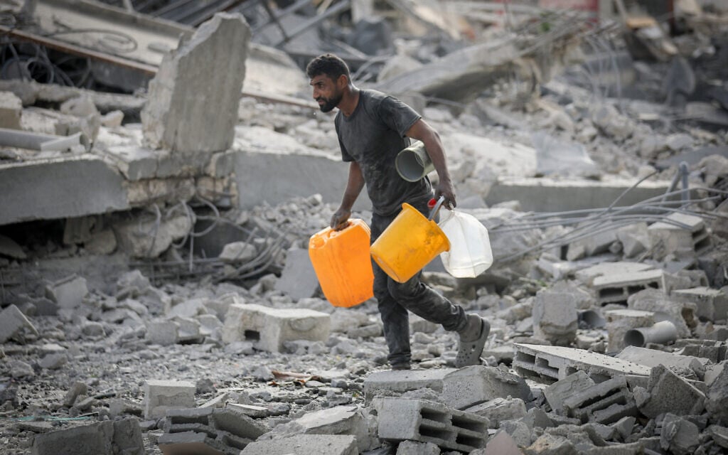 Palestinians at the site of an Israeli airstrike that targeted a house in al-Bureij camp, central Gaza Strip, on July 30, 2026. (Ali Hassan/Flash90)