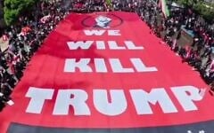 A large sign saying "We will kill Trump" is carried by funeral-goers in Mashhad, Iran, where supreme leader Ali Khamenei was being buried on July 9, 2026. (via X,  used in accordance with Clause 27a of the Copyright Law)