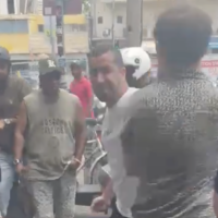 A man strikes an activist with The Democrats party in south Tel Aviv's Hatikvah Market on July 3, 2026. (Screen capture: X, used in accordance with Clause 27a of the Copyright Law)