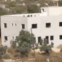 Soldiers and settlers are seen at an under-construction Palestinian home that the settlers seized in the northern West Bank village of Jalud, in a video published by Palestinian media in late June 2026. (Screen capture: X, used in accordance with Clause 27a of the Copyright Law)