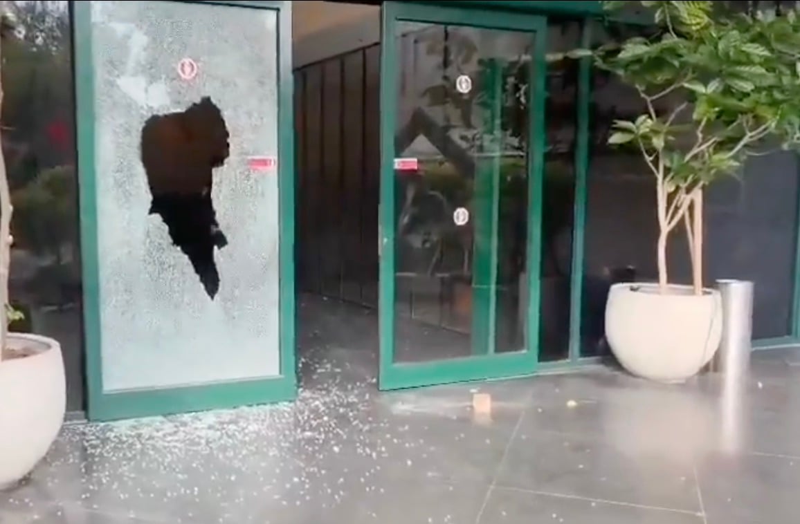 Door to Channel 12 news offices smashed by masked assailant in Tel Aviv