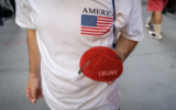 A Jewish supporter of US President Donald Trump holds a Trump kippah in front of Trump Tower in midtown Manhattan, November 6, 2024. (Luke Tress/Times of Israel)