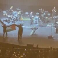 Members of the band Massive Attack display a Palestinian flag at their concert in Singapore, July 29, 2026. (X video: used in accordance with Clause 27a of the Copyright Law)