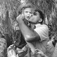 Five-year-old Ella Rosenkovitch is held and kissed at celebrations following the return of return of Israeli hostages from Entebbe, July 4, 1976. 'I don't know who the man in this picture is,' she says. (Courtesy)