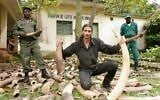 Ofir Drori poses in Cameroon with elephant tusks seized from an African-Asian crime syndicate. (Courtesy, EAGLE)