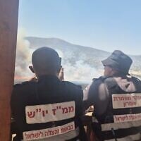 Emergency personnel look on as a fire burns near the site of a suspected stabbing attack in the West Bank on July 23, 2026. (Fire and Rescue Service)