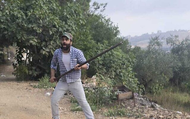 A Palestinian in seen confronting settlers with a pole during a deadly clash near the West Bank village of Tell on July 24, 2026 (Courtesy)