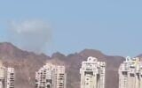 A plume of smoke is seen in the distance from Eilat after an Iranian missile attack on Jordan on July 22, 2026. (Screen capture: Telegram)