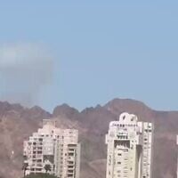 A plume of smoke is seen in the distance from Eilat after an Iranian missile attack on Jordan on July 22, 2026. (Screen capture: Telegram)