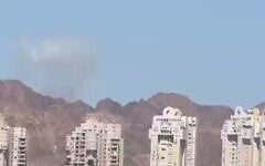 A plume of smoke is seen in the distance from Eilat after an Iranian missile attack on Jordan on July 22, 2026. (Screen capture: Telegram)