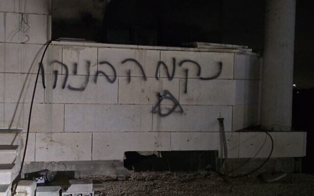 "Benayahu's revenge" graffiti is seen on a mosque that was also set on fire, July 26, 2026, in the West Bank village of Qusra. (Screenshot via X, used in accordance with Clause 27a of the Copyright Law)