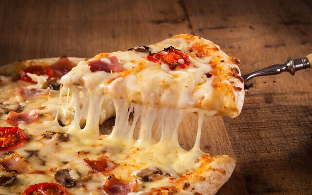 A slice of pizza. Beta-casein, successfully engineered into a plant at Jerusalem's Hebrew University, is one of the milk proteins responsible for making cheese melts. (Proformabooks, iStock by Getty Images)