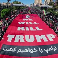 A large sign saying "We will kill Trump" is carried by funeral-goers in Mashhad, Iran, where supreme leader Ali Khamenei was being buried on July 9, 2026. (via X, used in accordance with Clause 27a of the Copyright Law)