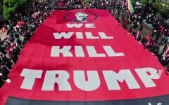 A large sign saying "We will kill Trump" is carried by funeral-goers in Mashhad, Iran, where supreme leader Ali Khamenei was being buried on July 9, 2026. (via X, used in accordance with Clause 27a of the Copyright Law)