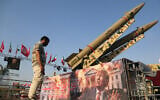 A man looks at a banner depicting US President Donald Trump displayed in front of the Zolfaghar and Zolghadr ballistic missiles exhibited at Azadi Square in Tehran, Iran's capital, on August 2, 2026. (Fatemeh Bahrami / Anadolu via Reuters)