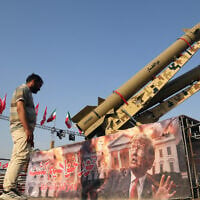 A man looks at a banner depicting US President Donald Trump displayed in front of the Zolfaghar and Zolghadr ballistic missiles exhibited at Azadi Square in Tehran, Iran's capital, on August 2, 2026. (Fatemeh Bahrami / Anadolu via Reuters)