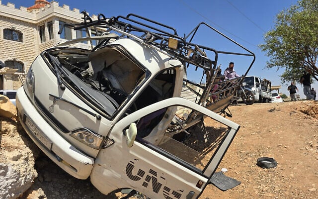 A damaged vehicle is seen following a reported attack by an Israeli army unmanned aerial vehicle (UAV) in the countryside of Quneitra, Syria, on August 22, 2026. (Huseyin Mesal / Anadolu)