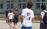A teenager wearing a shirt appearing to depict Palestinian terrorist Dalal Mughrabi is seen at the Nazi Mauthausen Concentration Camp Memorial in Austria. (X video screenshot; used in accordance with Clause 27a of the Copyright Law)