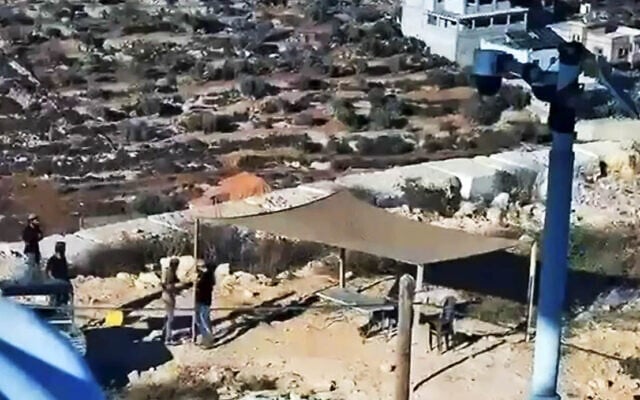 Settlers outside the home of Youssef Hassan in the West Bank village of Qusra, south of Nablus, August 10, 2026. (Courtesy)