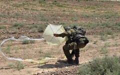 A soldier seen inspecting a kite, apparently flown from the Gaza Strip, that has landed in Kibbutz Nahal Oz, August 22, 2026. (Social media, used in accordance with Clause 27a of the Copyright Law)