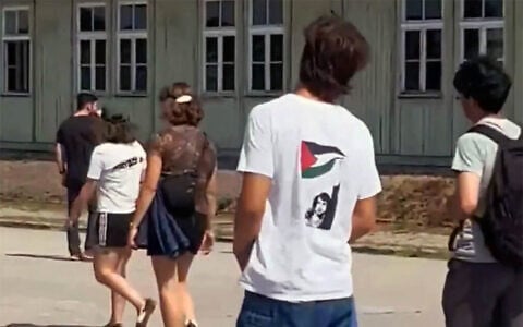 A teenager wearing a shirt appearing to depict Palestinian terrorist Dalal Mughrabi is seen at the Nazi Mauthausen Concentration Camp Memorial in Austria. (X video screenshot; used in accordance with Clause 27a of the Copyright Law)