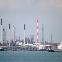 Illustrative: An oil tanker (R) sails past petroleum refineries on Bukom Island off Singapore on March 17, 2022. (Roslan RAHMAN/AFP)