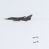 This handout picture released by Iran’s Army office on July 24, 2023, shows an Islamic Republic of Iran Air Force Sukhoi Su-24 tactical bomber aircraft releasing bombs during the Fadayeeyan Hareem Velayat aerial exercise in Iran. (Iranian Army office/AFP)
