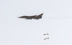 This handout picture released by Iran’s Army office on July 24, 2023, shows an Islamic Republic of Iran Air Force Sukhoi Su-24 tactical bomber aircraft releasing bombs during the Fadayeeyan Hareem Velayat aerial exercise in Iran. (Iranian Army office/AFP)